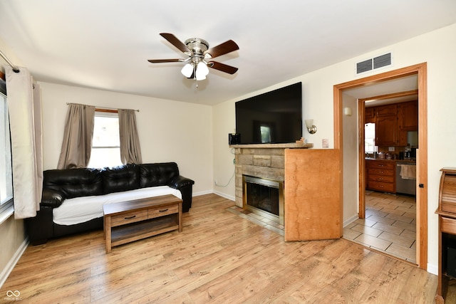 4020 S Lynhurst Dr, Indianapolis, IN 46221 - living room with a fireplace with flush hearth, ceiling fan, and wood finished floors