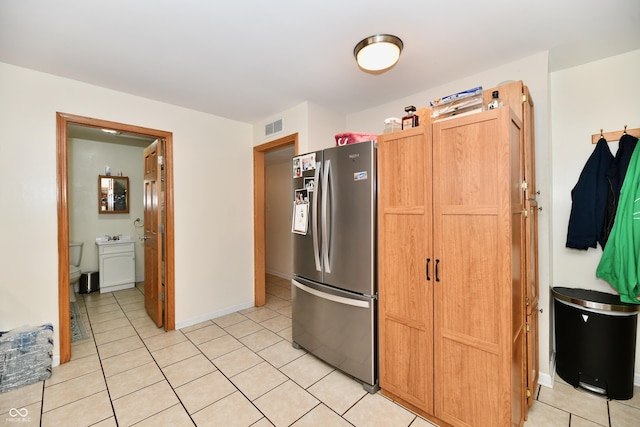 4020 S Lynhurst Dr, Indianapolis, IN 46221 - kitchen with freestanding refrigerator and light tile patterned flooring