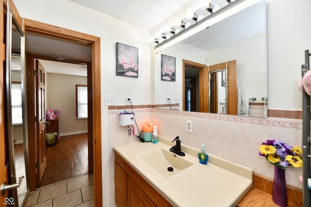 4020 S Lynhurst Dr, Indianapolis, IN 46221 - bathroom with tile walls, vanity, tile patterned flooring, and a wainscoted wall