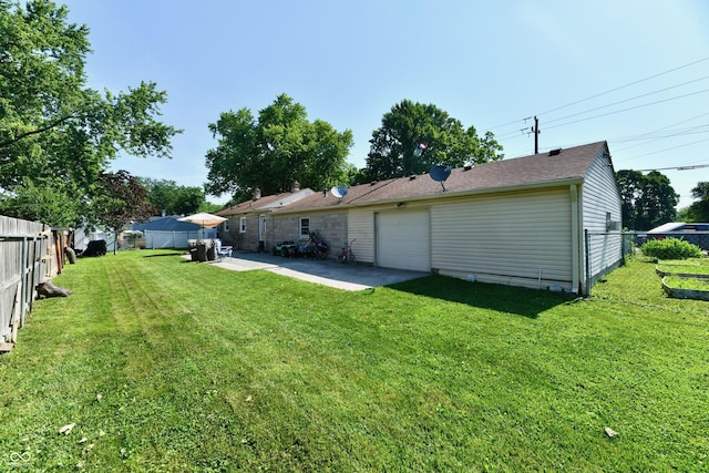 4020 S Lynhurst Dr, Indianapolis, IN 46221 - fenced backyard with a garage and a patio area