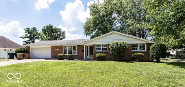 3040 Revere Ct, Columbus, IN 47203 - ranch-style home featuring driveway, brick siding, a garage, and a front yard