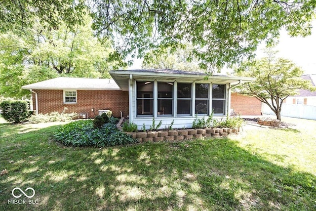 3040 Revere Ct, Columbus, IN 47203 - back of house featuring brick siding and a sunroom