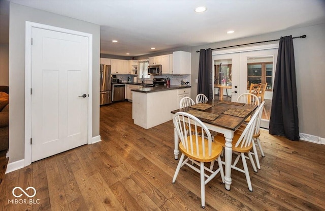 3040 Revere Ct, Columbus, IN 47203 - dining space with french doors, dark wood-style floors, and recessed lighting