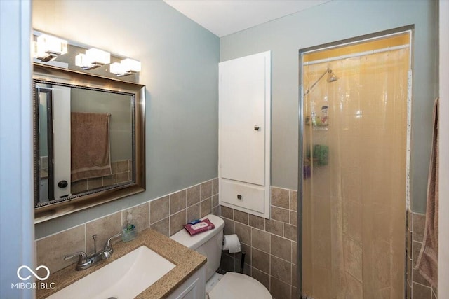 3040 Revere Ct, Columbus, IN 47203 - bathroom with a shower stall, tile walls, vanity, and wainscoting