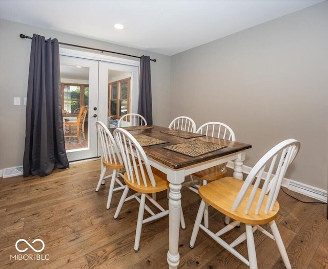 3040 Revere Ct, Columbus, IN 47203 - dining room with french doors, baseboard heating, wood finished floors, and recessed lighting