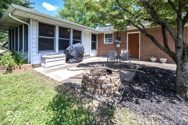 3040 Revere Ct, Columbus, IN 47203 - rear view of house with a fire pit, a patio area, and brick siding