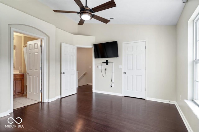 8256 Jo Ellen Dr, Fishers, IN 46038 - unfurnished bedroom featuring wood finished floors, vaulted ceiling, connected bathroom, and a ceiling fan