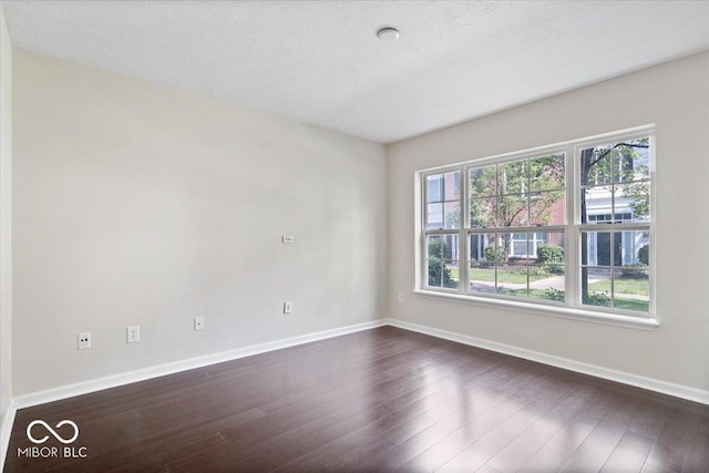 8256 Jo Ellen Dr, Fishers, IN 46038 - unfurnished room with dark wood-type flooring and a textured ceiling