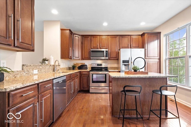8256 Jo Ellen Dr, Fishers, IN 46038 - kitchen featuring stainless steel appliances, plenty of natural light, wood finished floors, a kitchen island, and recessed lighting