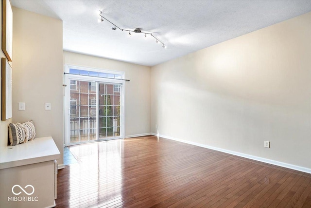 8256 Jo Ellen Dr, Fishers, IN 46038 - unfurnished living room with dark wood-style flooring and rail lighting