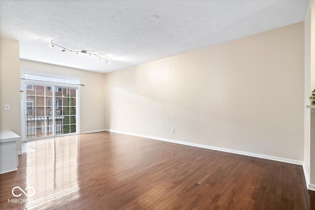 8256 Jo Ellen Dr, Fishers, IN 46038 - unfurnished room with dark wood finished floors and track lighting