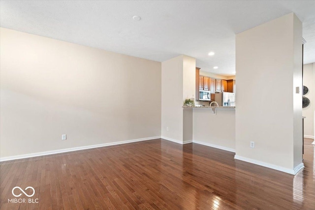 8256 Jo Ellen Dr, Fishers, IN 46038 - unfurnished living room featuring dark wood-style flooring and recessed lighting