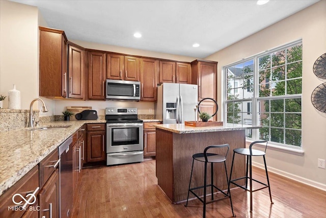 8256 Jo Ellen Dr, Fishers, IN 46038 - kitchen with stainless steel appliances, healthy amount of natural light, light stone counters, wood finished floors, and recessed lighting
