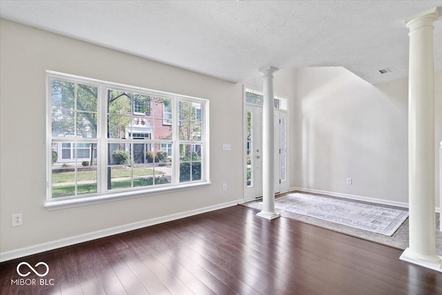 8256 Jo Ellen Dr, Fishers, IN 46038 - foyer entrance featuring ornate columns, wood finished floors, and a textured ceiling