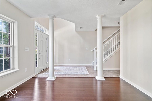 8256 Jo Ellen Dr, Fishers, IN 46038 - entryway with ornate columns, wood finished floors, and stairway