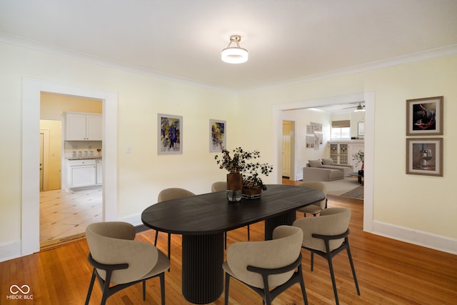 5050 Carrollton Ave, Indianapolis, IN 46205 - dining space featuring crown molding, light wood-style floors, and ceiling fan