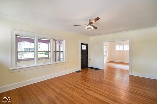 5050 Carrollton Ave, Indianapolis, IN 46205 - spare room featuring light wood finished floors, a ceiling fan, and ornamental molding