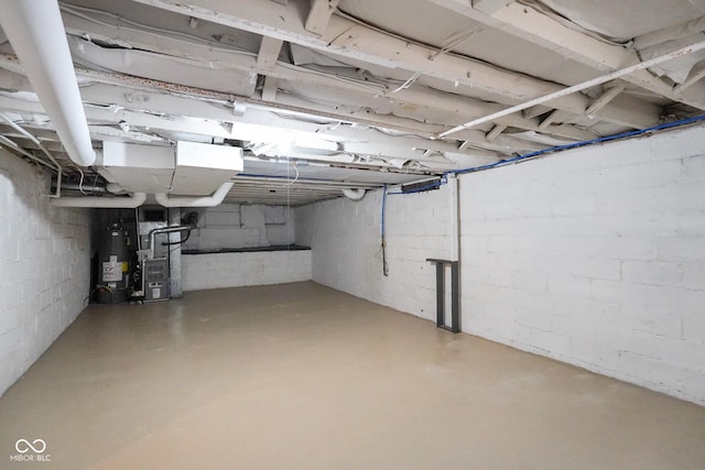5050 Carrollton Ave, Indianapolis, IN 46205 - unfinished basement featuring gas water heater, heating unit, and concrete block wall