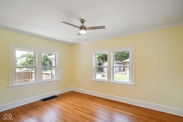 5050 Carrollton Ave, Indianapolis, IN 46205 - spare room featuring ornamental molding, light wood-style floors, and a ceiling fan