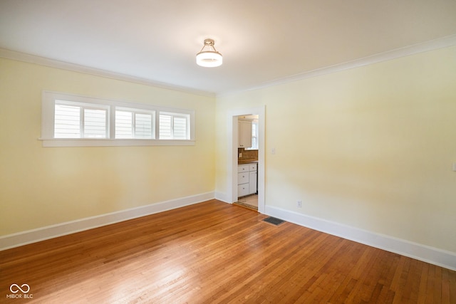 5050 Carrollton Ave, Indianapolis, IN 46205 - empty room featuring crown molding and light wood-style floors