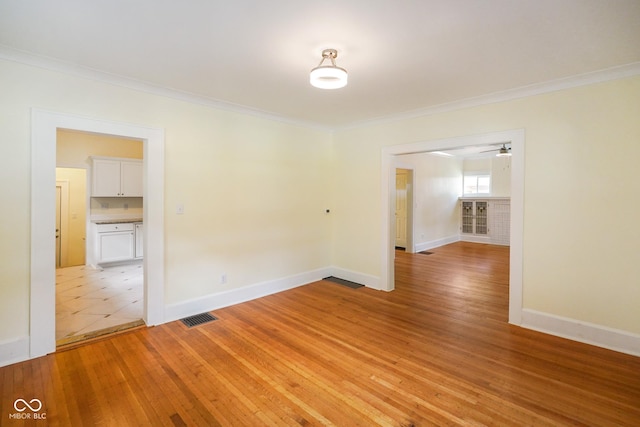 5050 Carrollton Ave, Indianapolis, IN 46205 - spare room featuring ornamental molding, light wood finished floors, and a ceiling fan