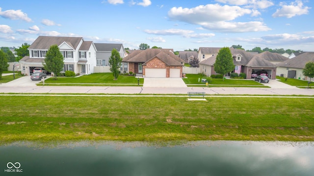 2533 Violet Way, Columbus, IN 47201 - view of front of home featuring a residential view, driveway, a garage, and a water view