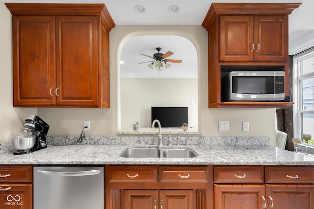 2533 Violet Way, Columbus, IN 47201 - kitchen featuring appliances with stainless steel finishes, a ceiling fan, light stone counters, and brown cabinetry