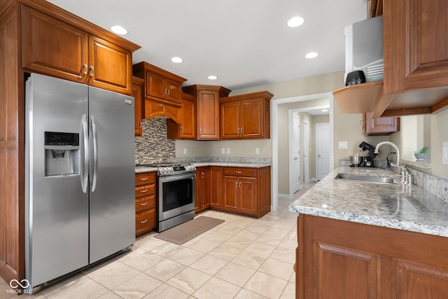 2533 Violet Way, Columbus, IN 47201 - kitchen featuring stainless steel appliances, backsplash, brown cabinetry, light stone counters, and recessed lighting