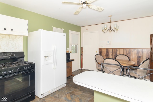 1003 N Broadway St, Greenfield, IN 46140 - kitchen with black range with gas cooktop, white refrigerator with ice dispenser, a ceiling fan, white cabinets, and a chandelier