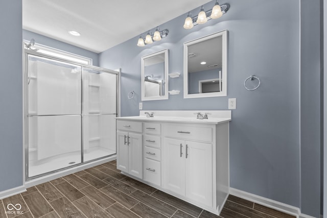 5398 Marigold Dr, Plainfield, IN 46168 - full bathroom featuring double vanity, wood finish floors, and a shower stall
