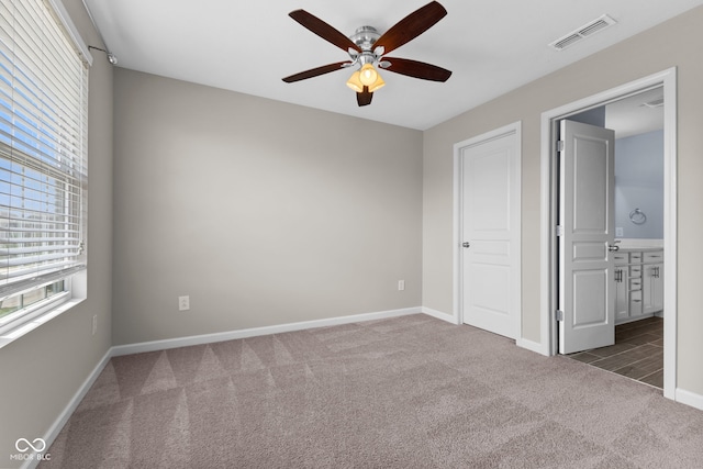 5398 Marigold Dr, Plainfield, IN 46168 - unfurnished bedroom with carpet flooring, connected bathroom, and ceiling fan