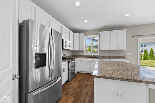 5398 Marigold Dr, Plainfield, IN 46168 - kitchen with appliances with stainless steel finishes, white cabinets, dark wood-type flooring, recessed lighting, and stone countertops