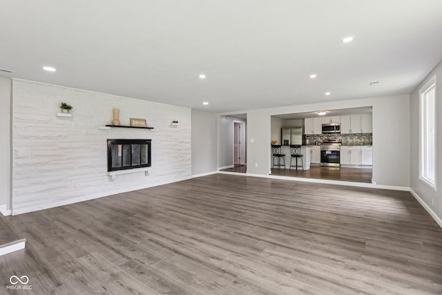 6233 Lafayette Rd, Indianapolis, IN 46278 - unfurnished living room featuring wood finished floors, a fireplace, and recessed lighting