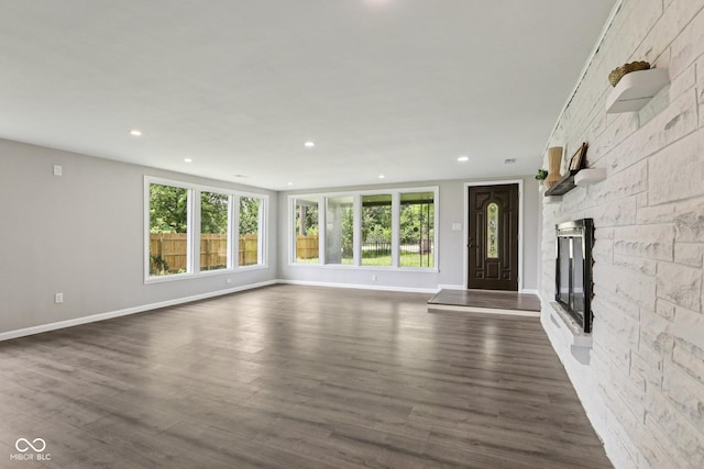 6233 Lafayette Rd, Indianapolis, IN 46278 - unfurnished living room featuring healthy amount of natural light, a fireplace, recessed lighting, and dark wood finished floors