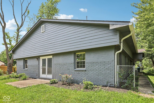6233 Lafayette Rd, Indianapolis, IN 46278 - rear view of house featuring brick siding, a patio, and a gate