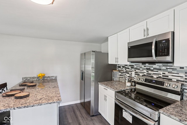 6233 Lafayette Rd, Indianapolis, IN 46278 - kitchen with appliances with stainless steel finishes, a peninsula, backsplash, and dark wood-style floors