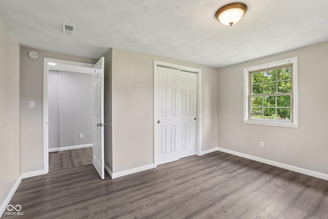 6233 Lafayette Rd, Indianapolis, IN 46278 - unfurnished bedroom featuring dark wood-type flooring and a closet