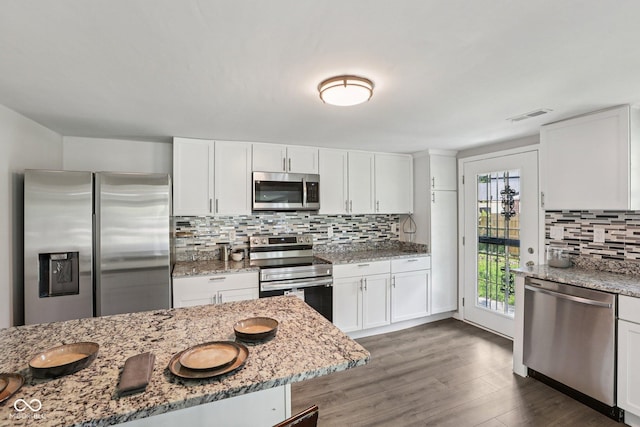 6233 Lafayette Rd, Indianapolis, IN 46278 - kitchen featuring appliances with stainless steel finishes, decorative backsplash, white cabinetry, and light stone counters