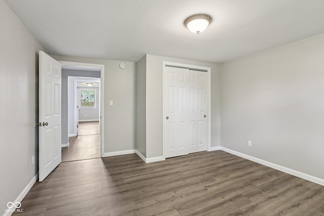 6233 Lafayette Rd, Indianapolis, IN 46278 - unfurnished bedroom with dark wood-style floors and a closet