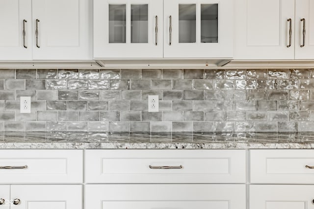 12861 Clifford Cir, Carmel, IN 46032 - detailed view of white cabinets, glass insert cabinets, light stone counters, and tasteful backsplash