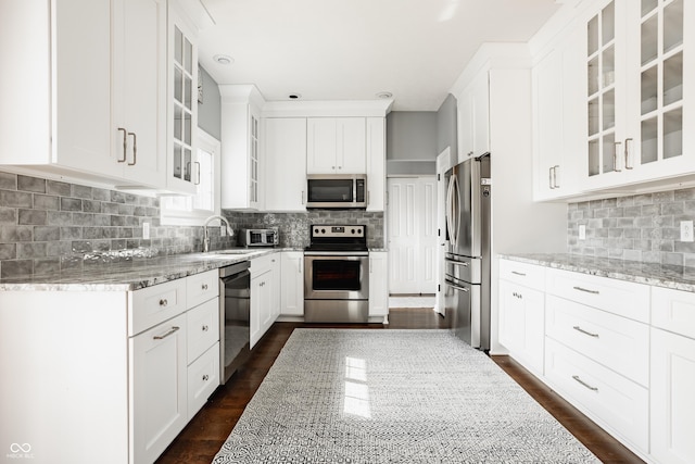 12861 Clifford Cir, Carmel, IN 46032 - kitchen with stainless steel appliances, light stone counters, and backsplash
