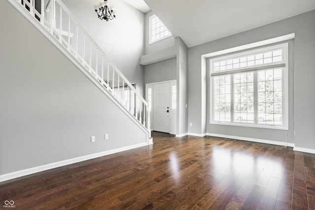 12861 Clifford Cir, Carmel, IN 46032 - entrance foyer with stairway, wood-type flooring, a high ceiling, and a chandelier