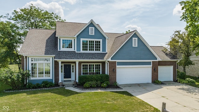 12861 Clifford Cir, Carmel, IN 46032 - view of front facade with a front lawn, brick siding, concrete driveway, an attached garage, and roof with shingles