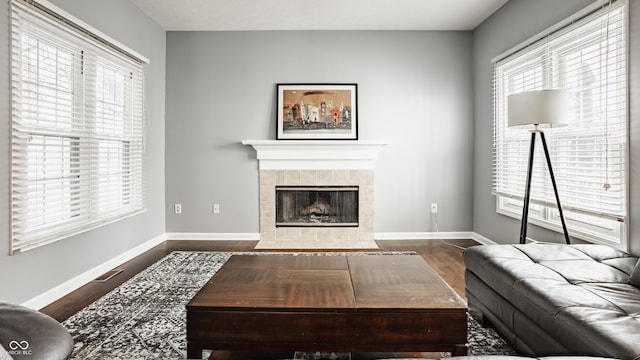 12861 Clifford Cir, Carmel, IN 46032 - living room with a tile fireplace and dark wood-style floors