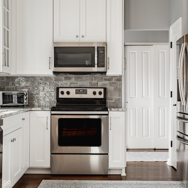 12861 Clifford Cir, Carmel, IN 46032 - kitchen with appliances with stainless steel finishes, white cabinets, light stone countertops, and backsplash