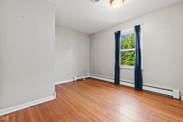 120 W N St, Tipton, IN 46072 - unfurnished room with hardwood / wood-style floors and a baseboard heating unit