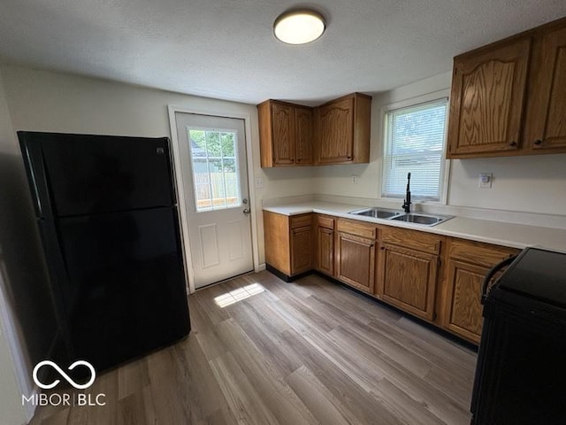 5725 N Clover Maple Dr, Fairland, IN 46126 - kitchen featuring black appliances, light wood finished floors, brown cabinets, and light countertops