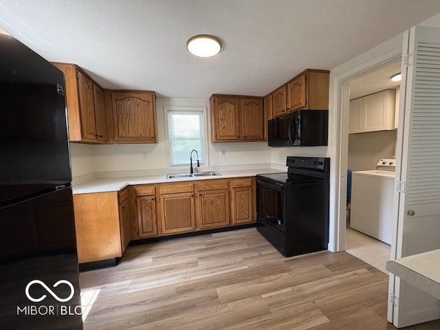 5725 N Clover Maple Dr, Fairland, IN 46126 - kitchen featuring black appliances, washer / clothes dryer, brown cabinetry, and light wood-type flooring