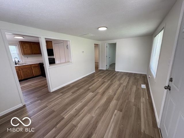 5725 N Clover Maple Dr, Fairland, IN 46126 - unfurnished living room featuring dark wood finished floors and a textured ceiling