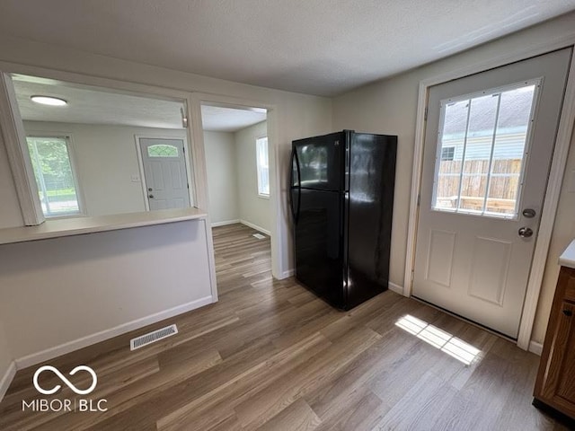 5725 N Clover Maple Dr, Fairland, IN 46126 - kitchen featuring freestanding refrigerator, wood finished floors, and light countertops